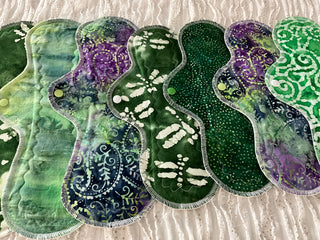 Set of green and purple patterned pads on a textured surface